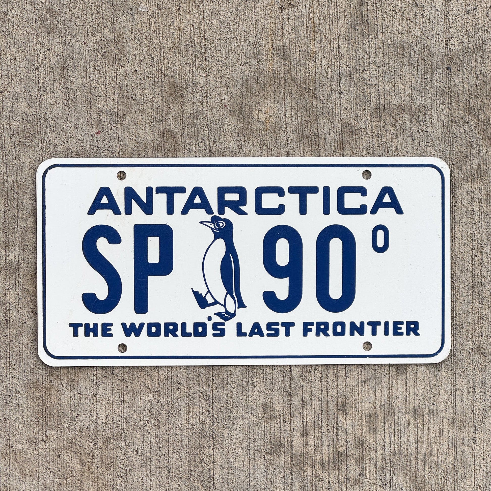 Photo of a 1960 Era Antarctica License Plate Auto Tag Garage Decor Vintage US Navy Operation Deep Freeze McMurdo Station Penguin SP 90 with original patina