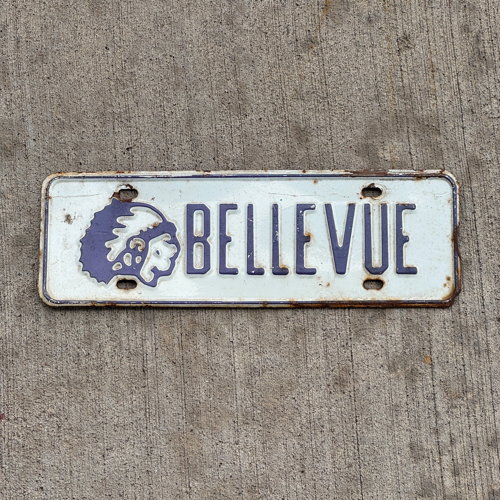 Photo of a 1960 Era Bellevue Chieftans Nebraska License Plate Topper Auto Tag Garage Decor Vintage High School with original patina