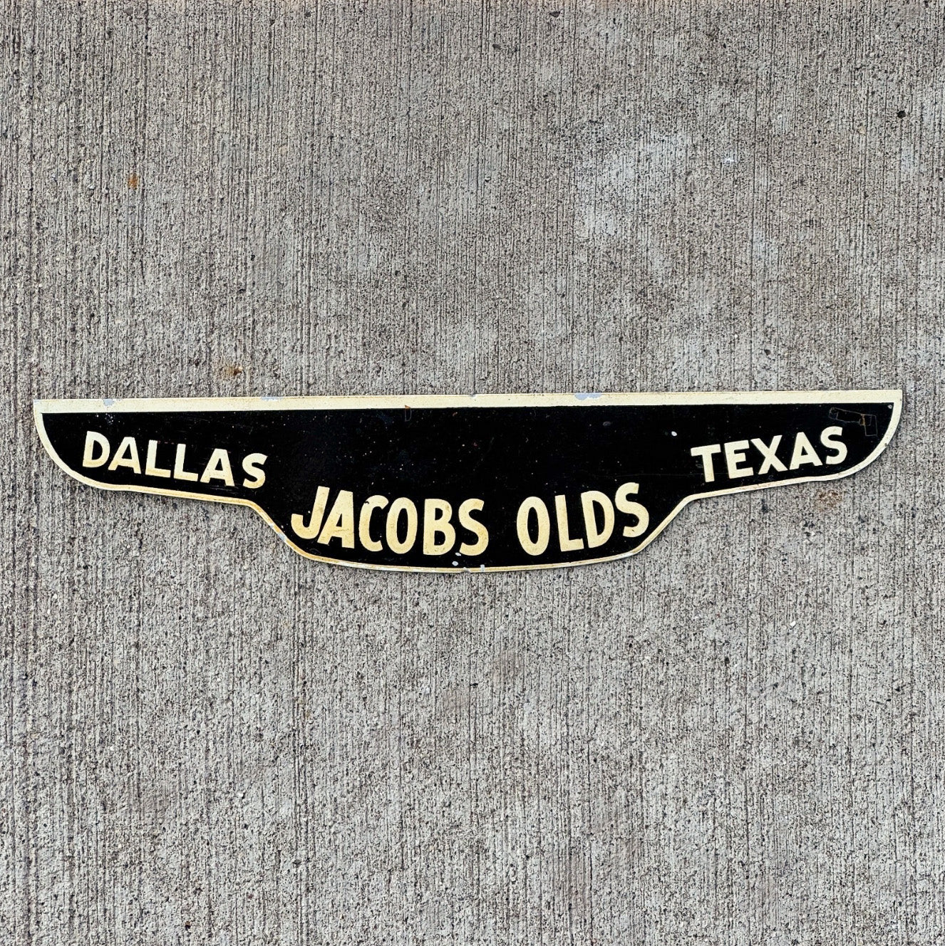Photo of a 1960 Era Dallas Texas License Plate Topper Auto Tag Garage Decor Vintage Jacobs Oldsmobile Dealer Olds with original patina