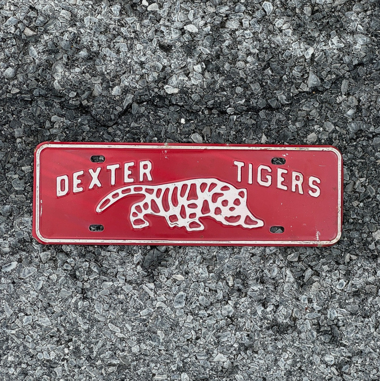 Photo of a 1960 Era Dexter Tigers Maine License Plate Topper Auto Tag Garage Decor Vintage High School Big Cat Graphic with original patina