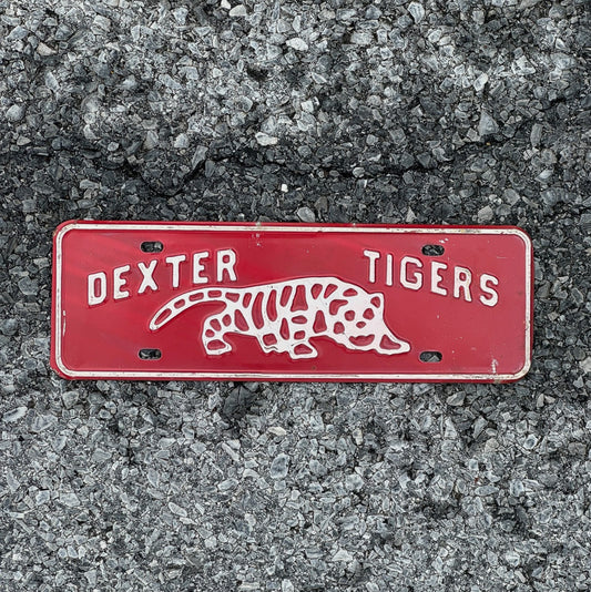 Photo of a 1960 Era Dexter Tigers Maine License Plate Topper Auto Tag Garage Decor Vintage High School Big Cat Graphic with original patina
