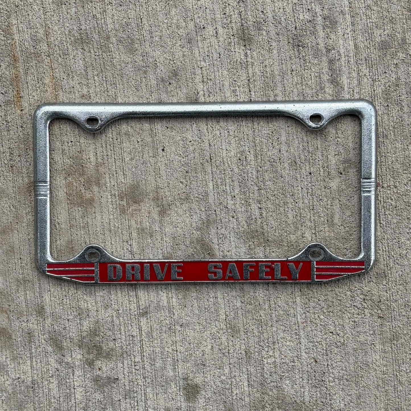 Photo of a 1960 Era Drive Safely License Plate Frame Auto Tag Garage Decor Vintage with original patina