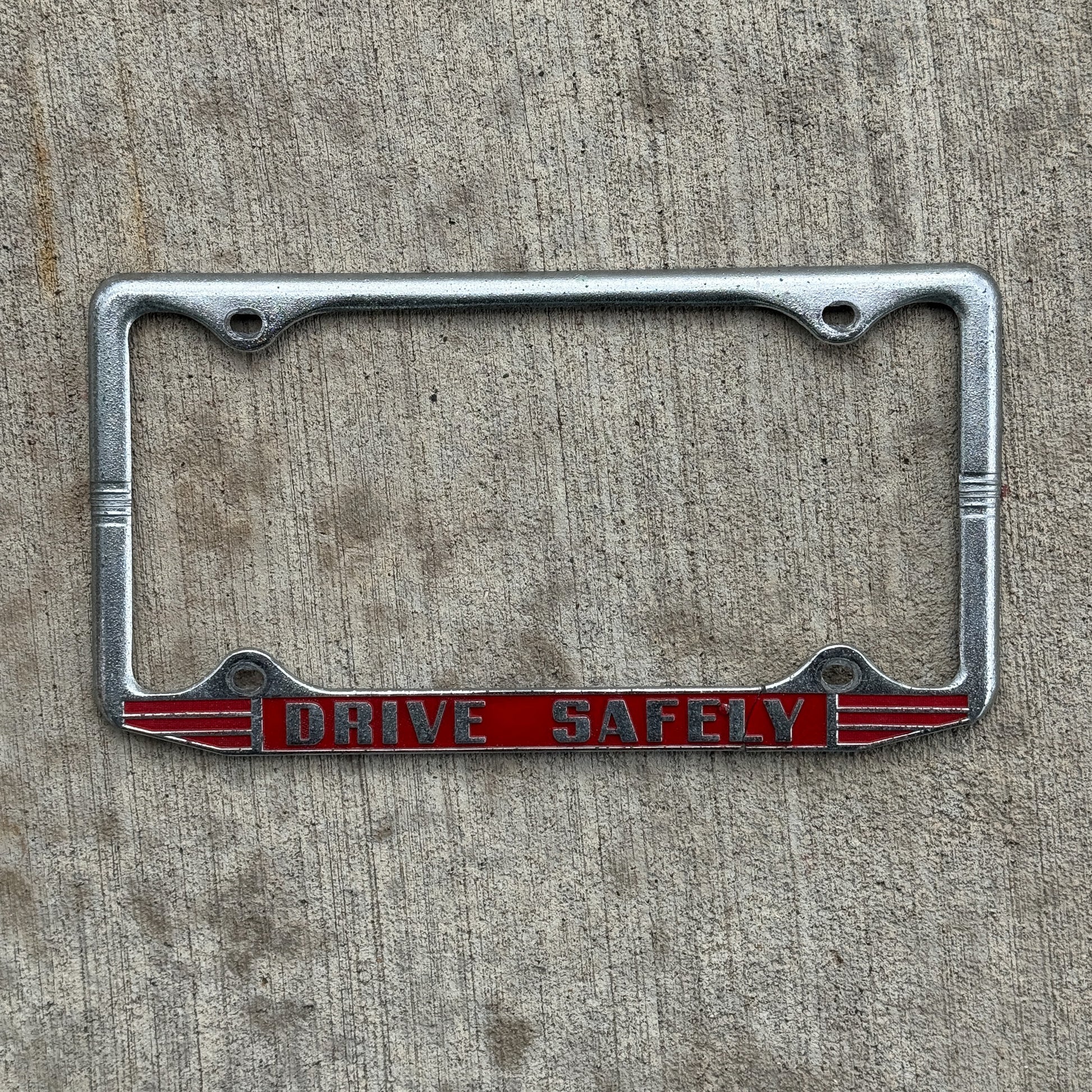 Photo of a 1960 Era Drive Safely License Plate Frame Auto Tag Garage Decor Vintage with original patina