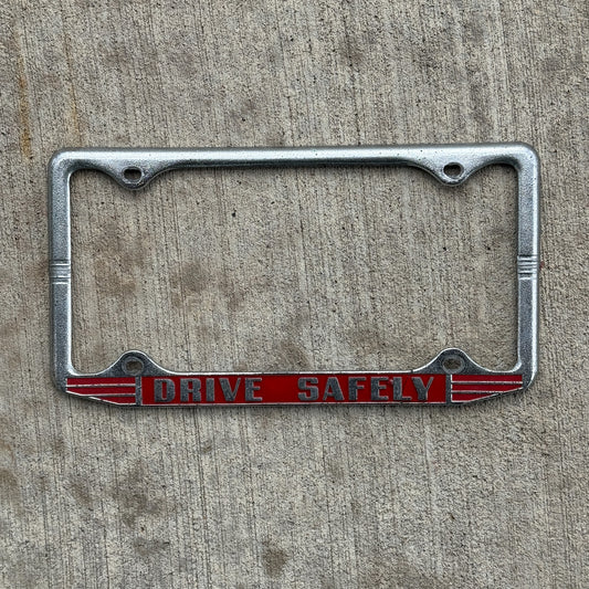 Photo of a 1960 Era Drive Safely License Plate Frame Auto Tag Garage Decor Vintage with original patina