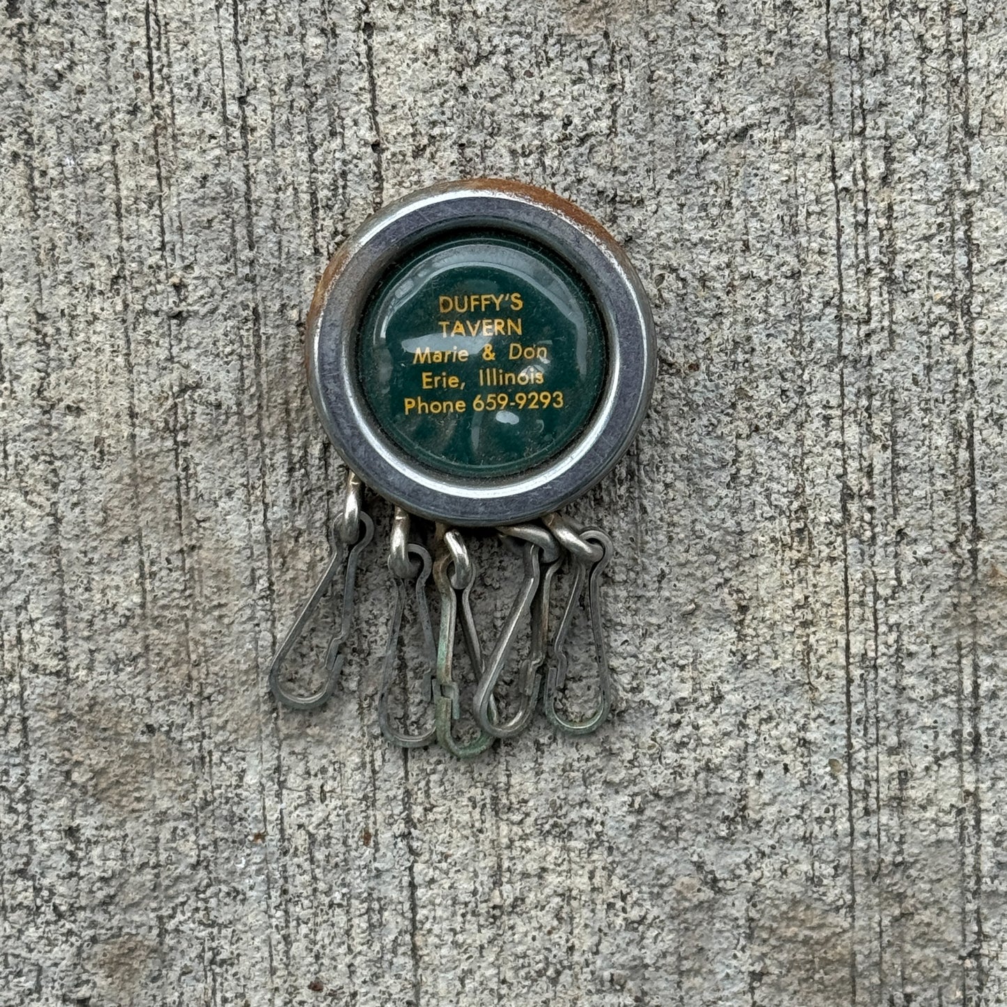 Photo of a 1960 Era Duffy's Tavern Erie Illinois Keychain Auto Tag Garage Decor Vintage Keychain Key Ring with original patina
