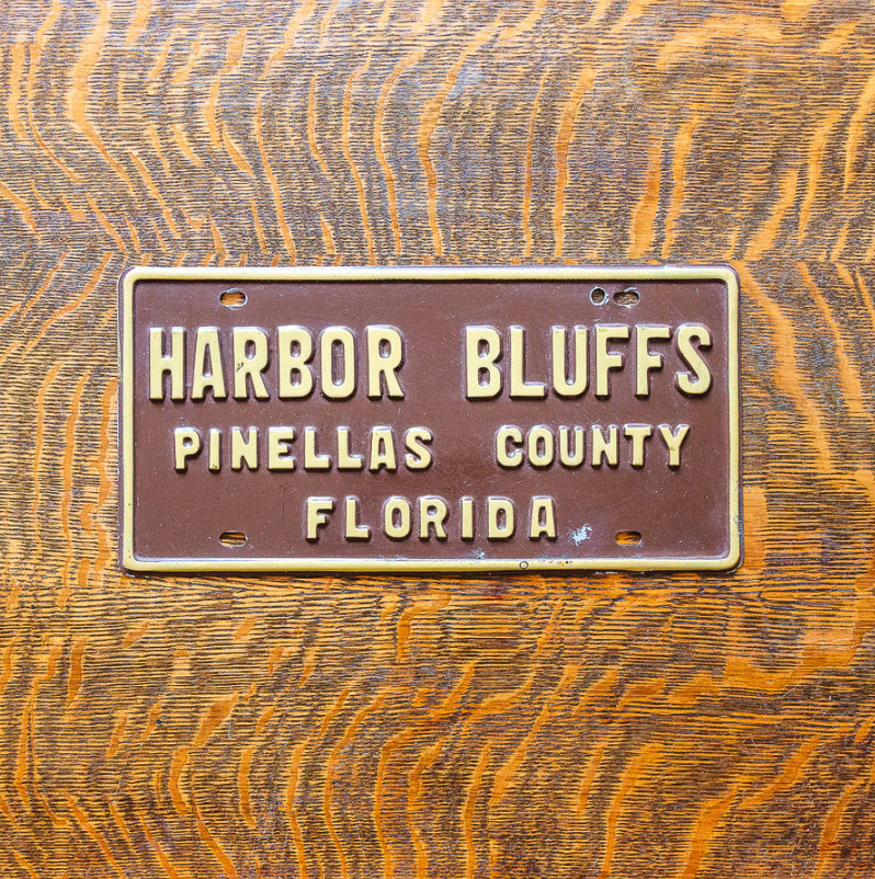 Photo of a 1960 Era Florida Booster License Plate Auto Tag Garage Decor Vintage Harbor Bluffs Pinellas County with original patina