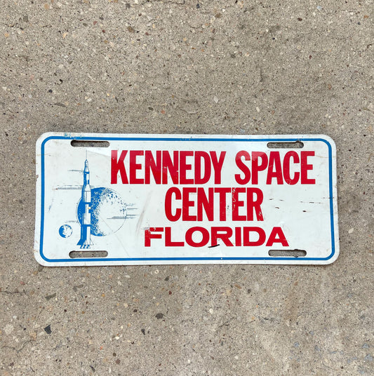 Photo of a 1960 Era Florida Booster License Plate Auto Tag Garage Decor Vintage Kennedy Space Center Cape Canaveral with original patina