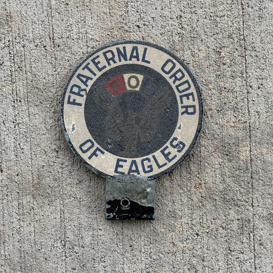 Photo of a 1960 Era Fraternal Order of Eagles FOE License Plate Topper Auto Tag Garage Decor Vintage Smaltz Reflective Paint with original patina