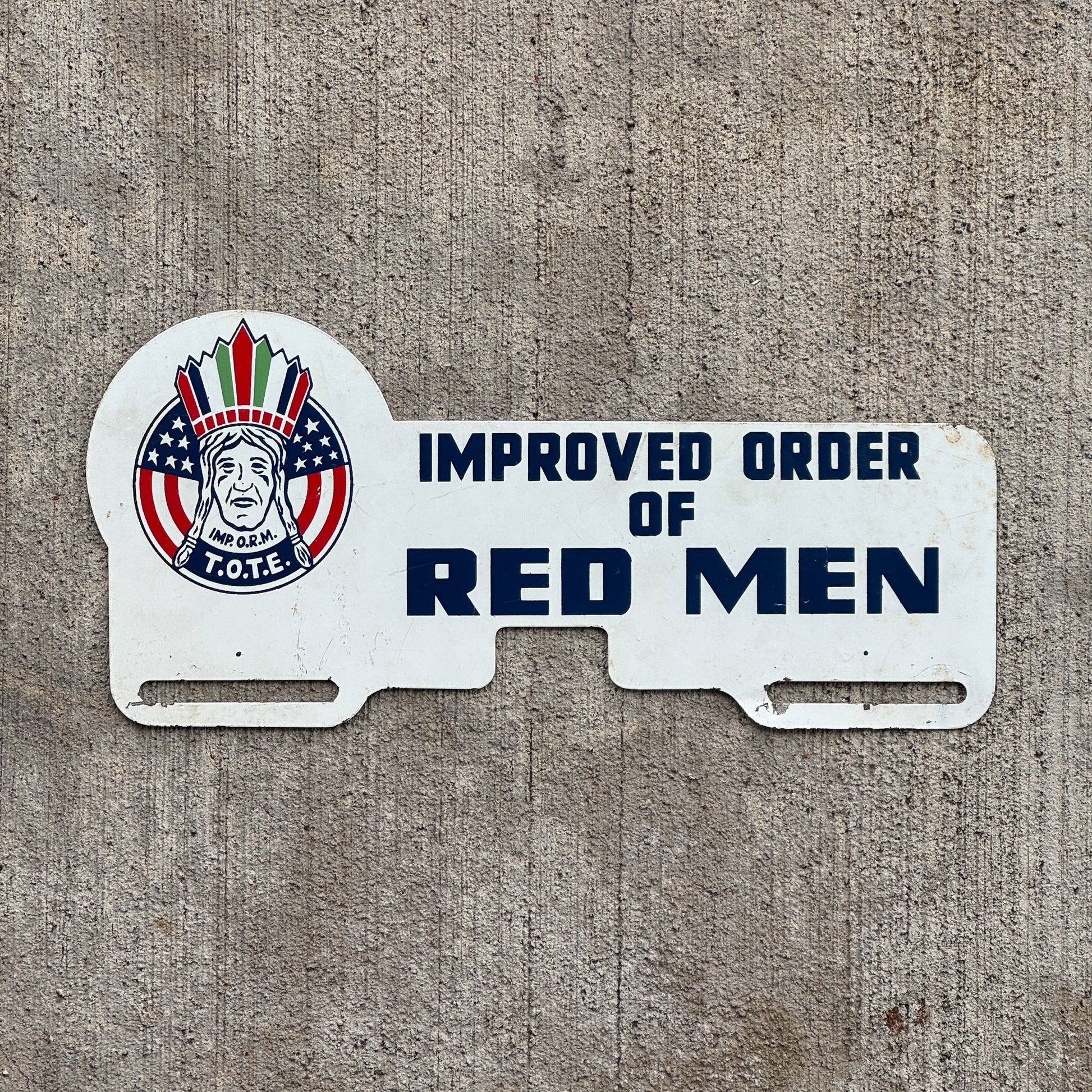 Photo of a 1960 Era Improved Order of Red Men License Plate Topper Auto Tag Garage Decor Vintage Fraternal Organization Native American Graphic with original patina
