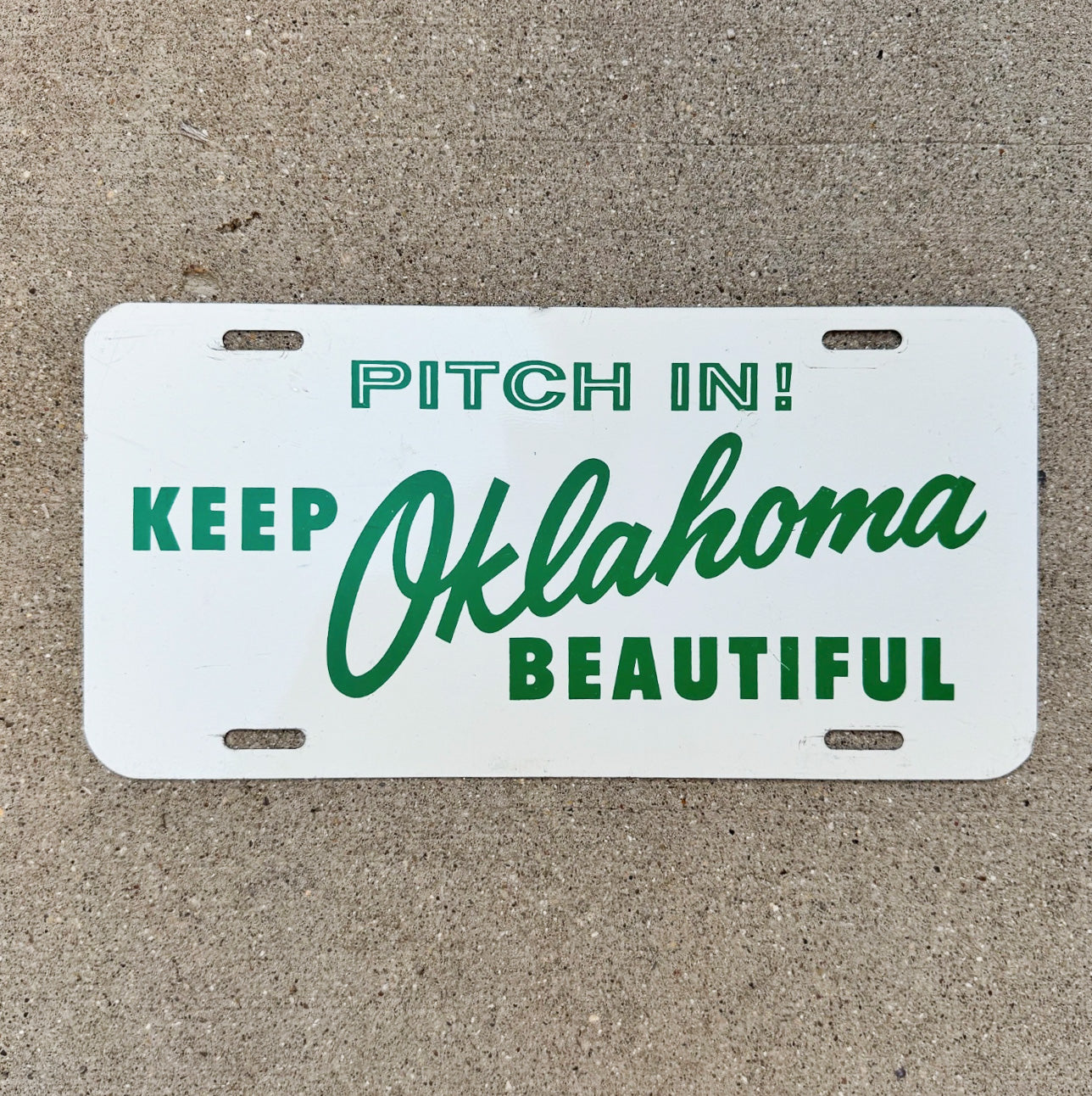 Photo of a 1960 Era Keep Oklahoma Booster License Plate Auto Tag Garage Decor Vintage Metal Pitch In with original patina