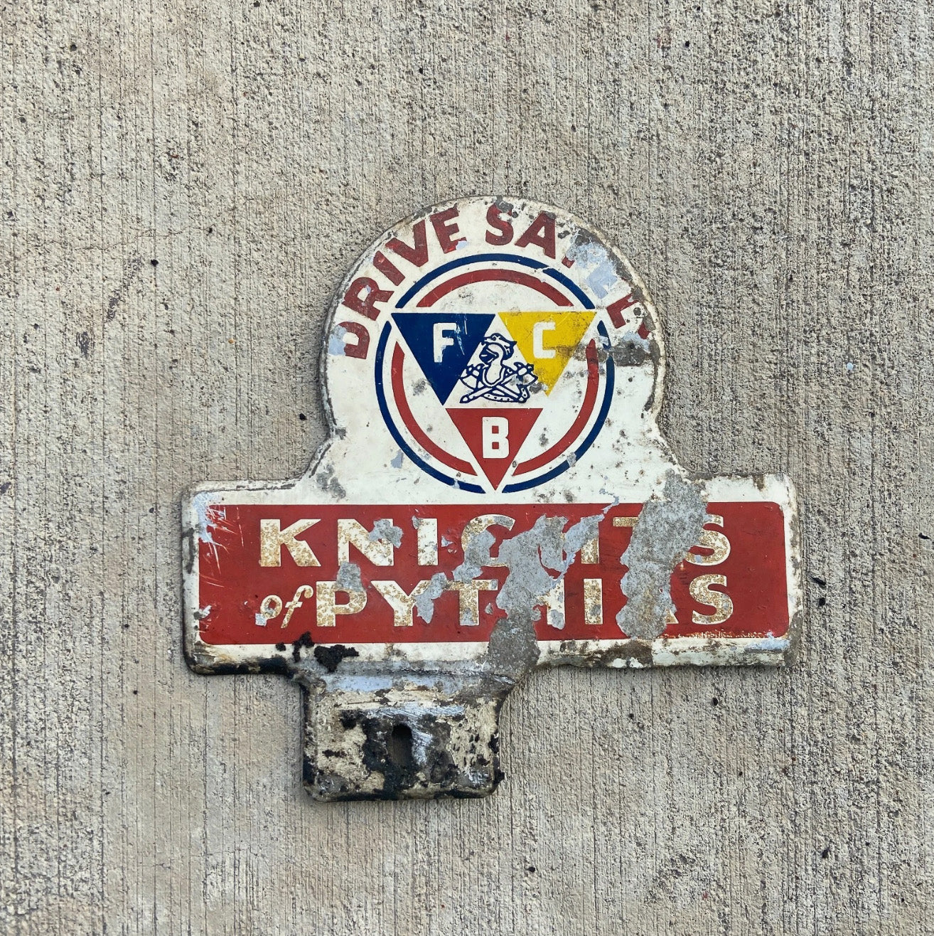 Photo of a 1960 Era Knights of Pythias License Plate Topper Auto Tag Garage Decor Vintage Drive Safely FCB Fraternal with original patina
