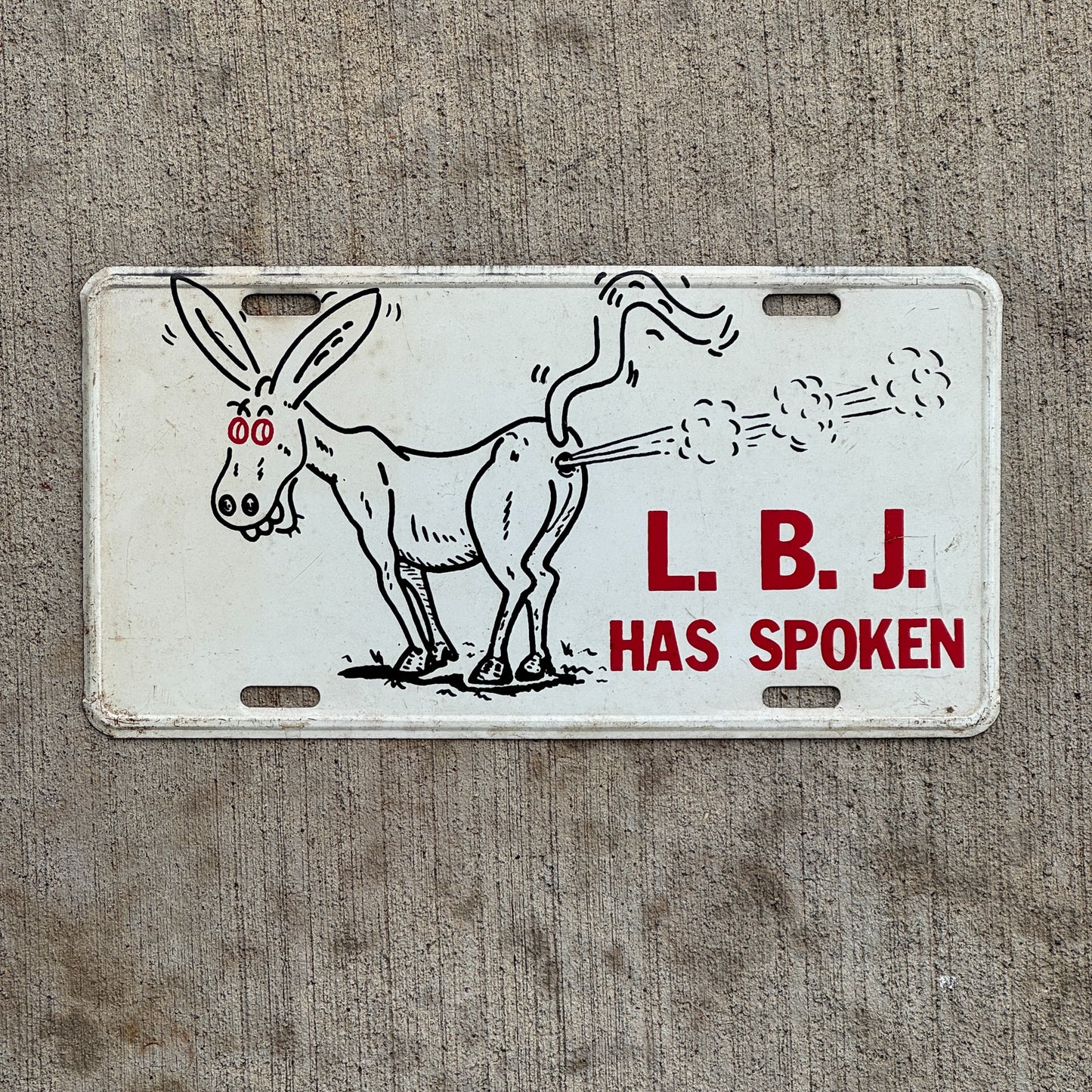 Photo of a 1960 Era LBJ Has Spoken Booster License Plate Auto Tag Garage Decor Vintage Political President Republican Ad with original patina