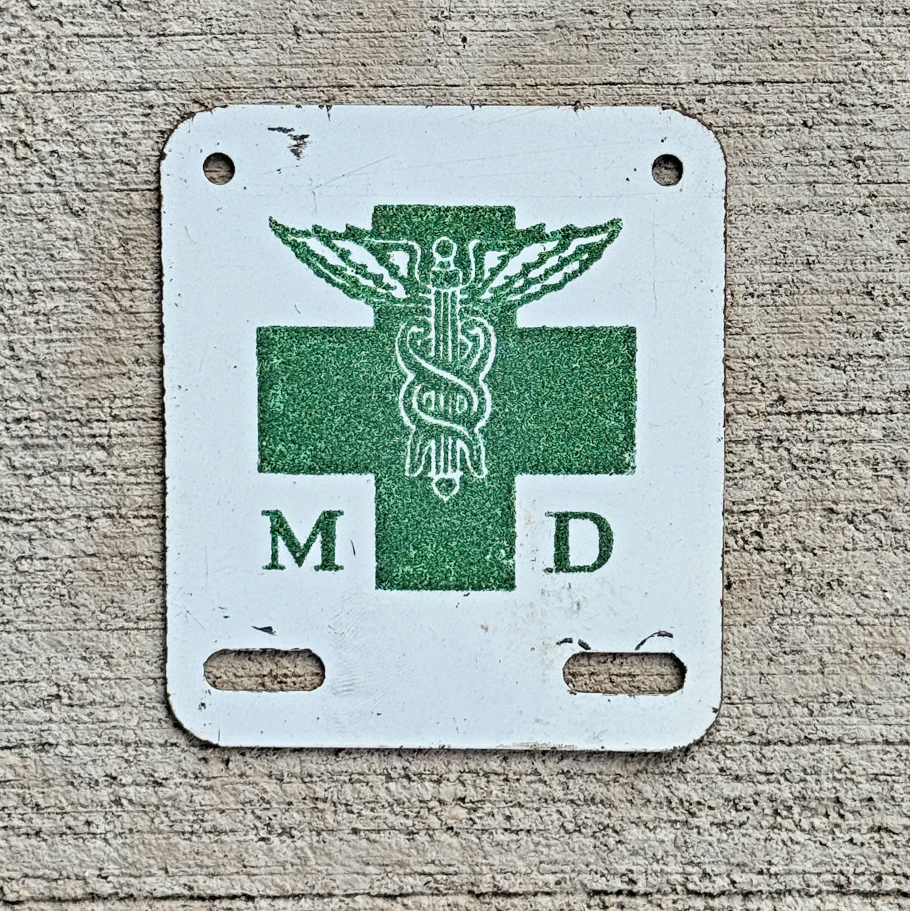 Photo of a 1960 Era Medical Doctor License Plate Topper Auto Tag Garage Decor Vintage Vintage Reflective Smaltz Paint Caduceus Graphic with original patina