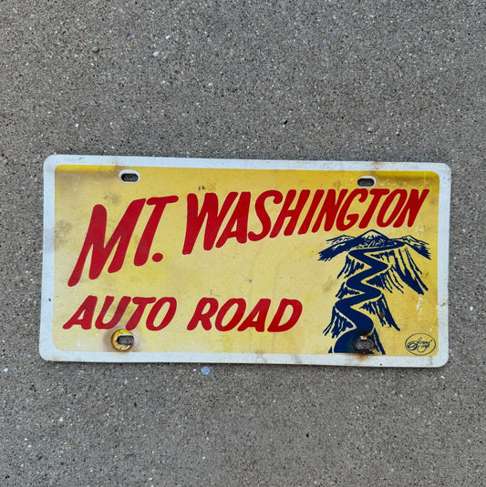 Photo of a 1960 Era Mt Washington New Hampshire Booster License Plate Auto Tag Garage Decor Vintage Fiber with original patina