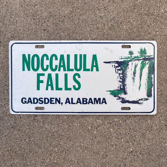 Photo of a 1960 Era Noccalula Falls Gadsden Alabama Booster License Plate Auto Tag Garage Decor Vintage Metal with original patina