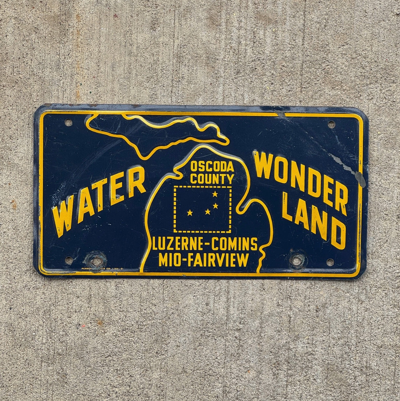 Photo of a 1960 Era Oscoda County Michigan Booster License Plate Auto Tag Garage Decor Vintage Water Wonderland with original patina