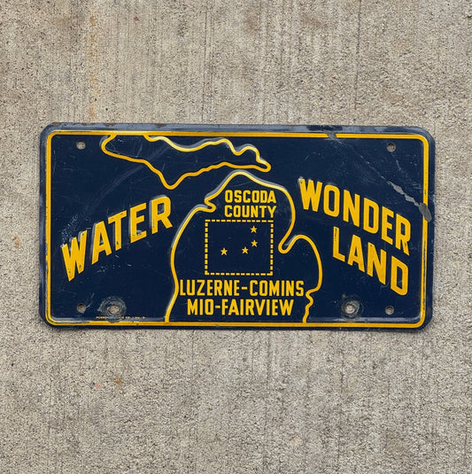 Photo of a 1960 Era Oscoda County Michigan Booster License Plate Auto Tag Garage Decor Vintage Water Wonderland with original patina