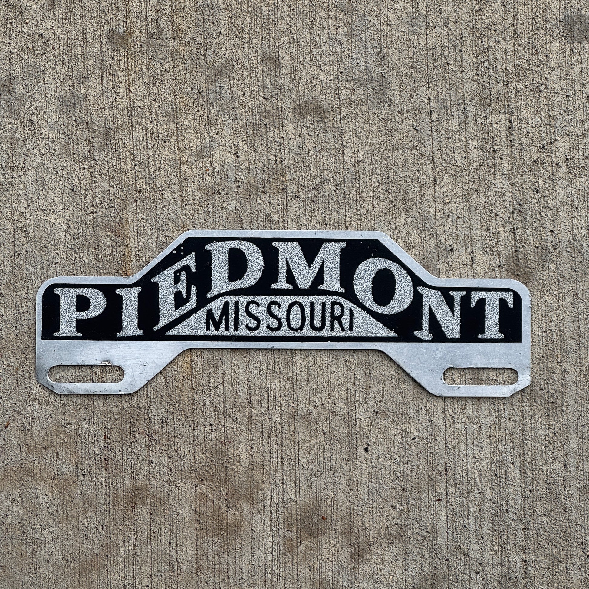 Photo of a 1960 Era Piedmont Missouri License Plate Topper Auto Tag Garage Decor Vintage Smaltz Reflective Paint with original patina