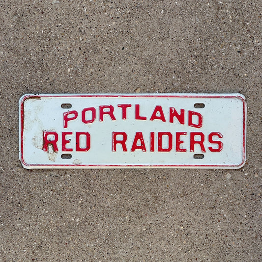 Photo of a 1960 Era Portland Michigan License Plate Topper Auto Tag Garage Decor Vintage Red Raiders with original patina