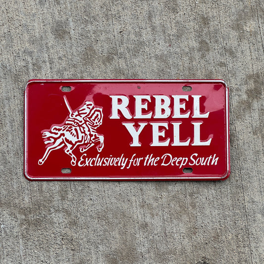 Photo of a 1960 Era Rebel Yell Booster License Plate Auto Tag Garage Decor Vintage Exclusively for the Deep South Metal with original patina