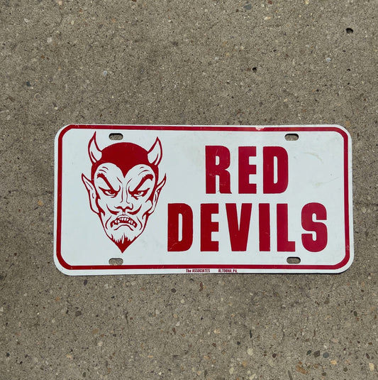 Photo of a 1960 Era Red Devils Booster License Plate Auto Tag Garage Decor Vintage High School Booster Metal 666 Evil with original patina