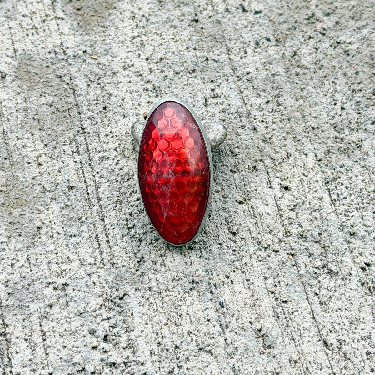 Photo of a 1960 Era Red Jewel Auto Tag Garage Decor Vintage Reflector Plastic Oval Bike Motorcycle Car with original patina