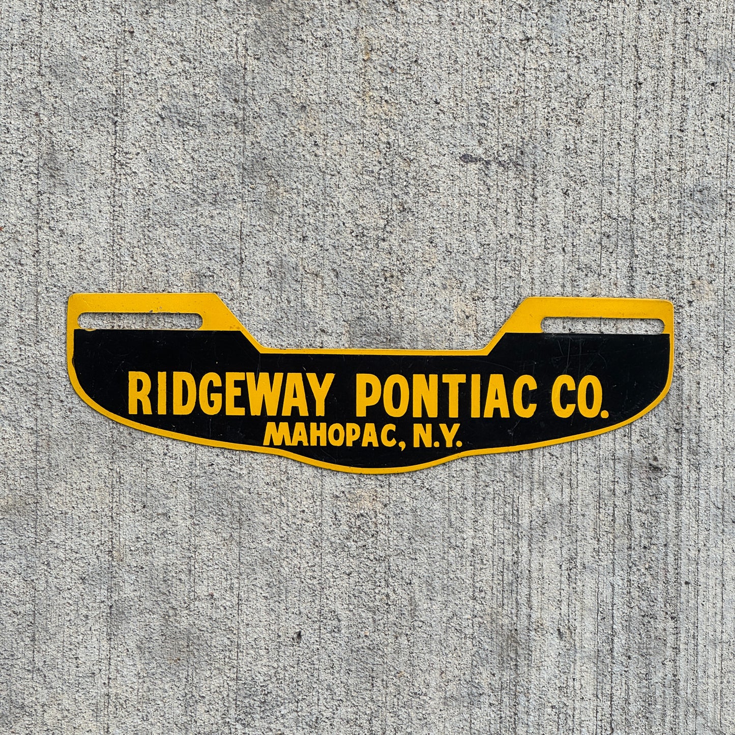 Photo of a 1960 Era Ridgeway Pontiac Co Mahopac New York License Plate Topper Auto Tag Garage Decor Vintage with original patina