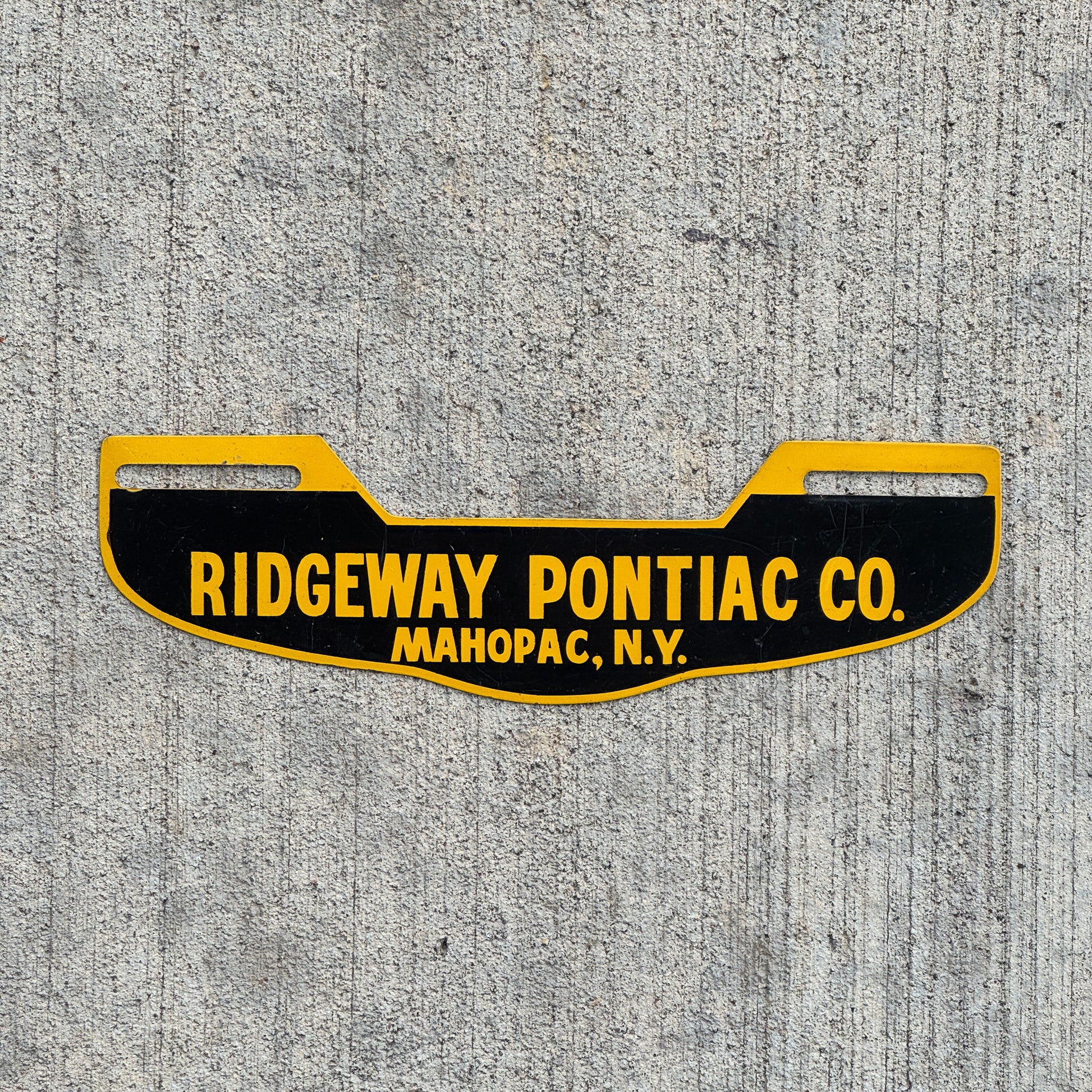Photo of a 1960 Era Ridgeway Pontiac Co Mahopac New York License Plate Topper Auto Tag Garage Decor Vintage with original patina