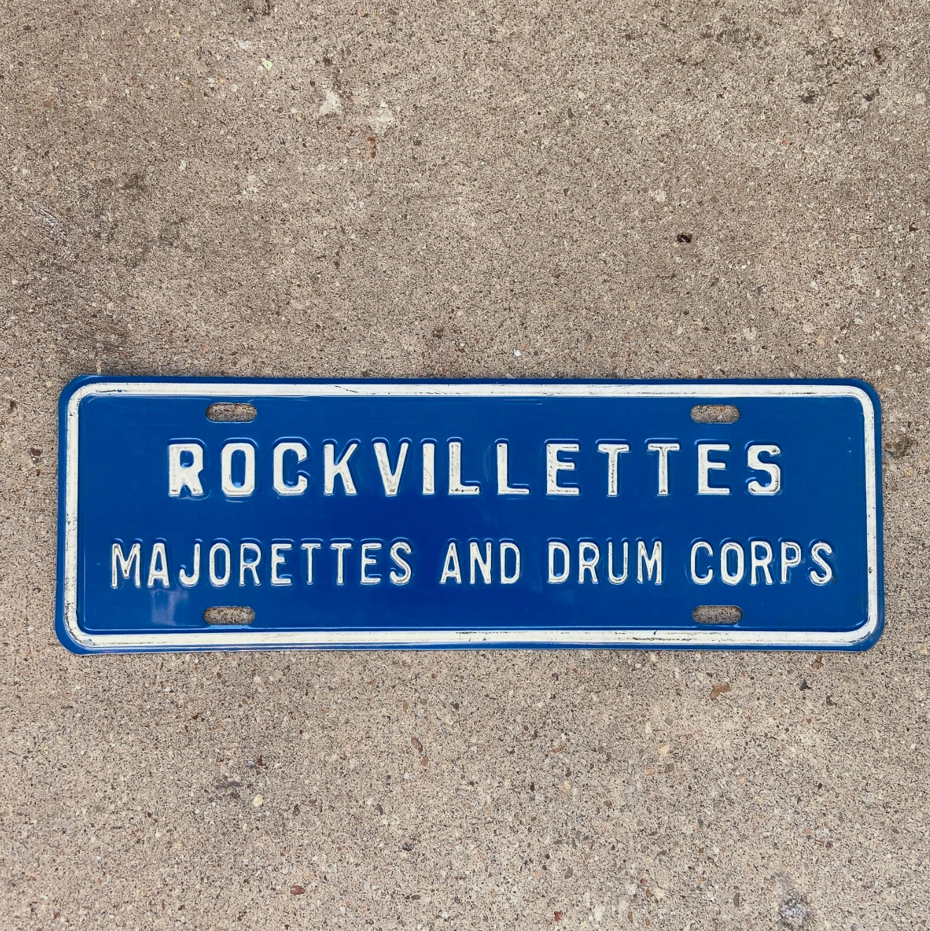 Photo of a 1960 Era Rockville Maryland License Plate Topper Auto Tag Garage Decor Vintage Rockvillettes Majorette Drum Corps with original patina