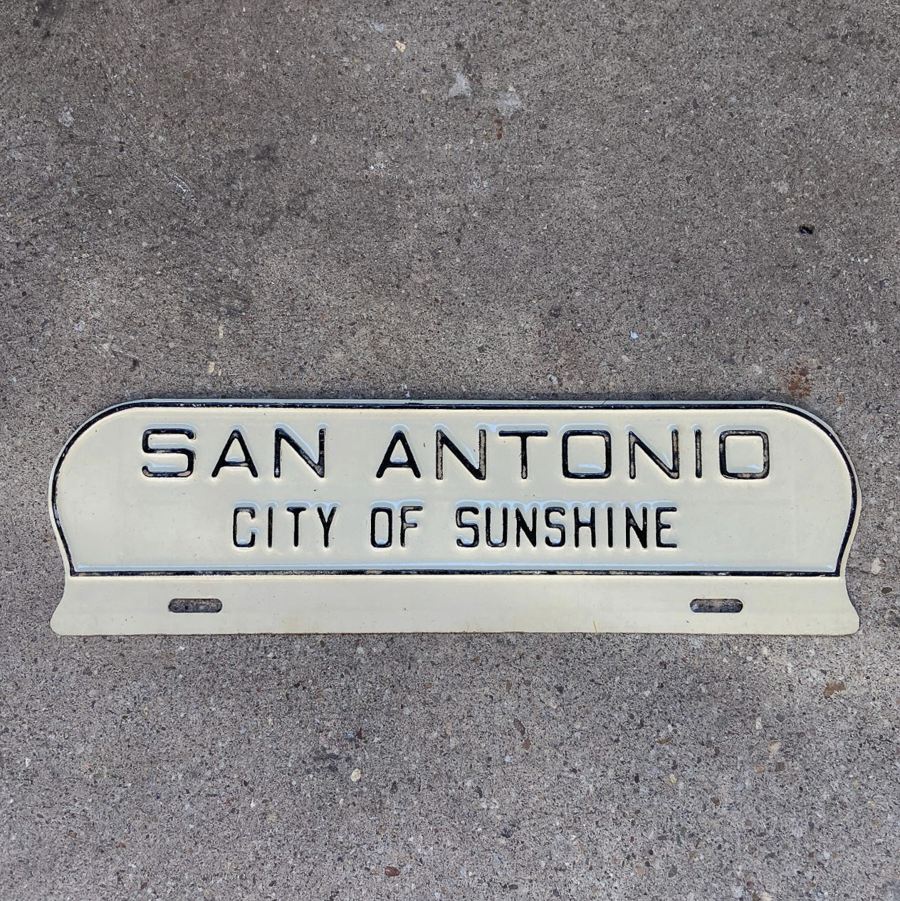 Photo of a 1960 Era San Antonio Texas License Plate Topper Auto Tag Garage Decor Vintage TX City of Sunshine Southern with original patina