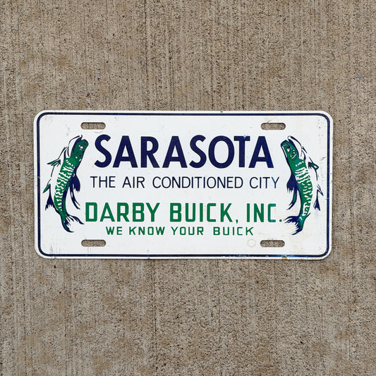 Photo of a 1960 Era Sarasota Florida Booster License Plate Auto Tag Garage Decor Vintage Darby Buick Fish Metal with original patina