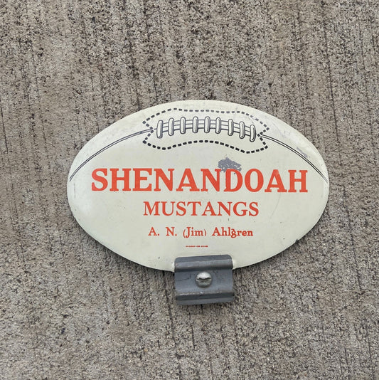 Photo of a 1960 Era Shenandoah Iowa License Plate Topper Auto Tag Garage Decor Vintage Amazing Football Graphic Mustangs with original patina