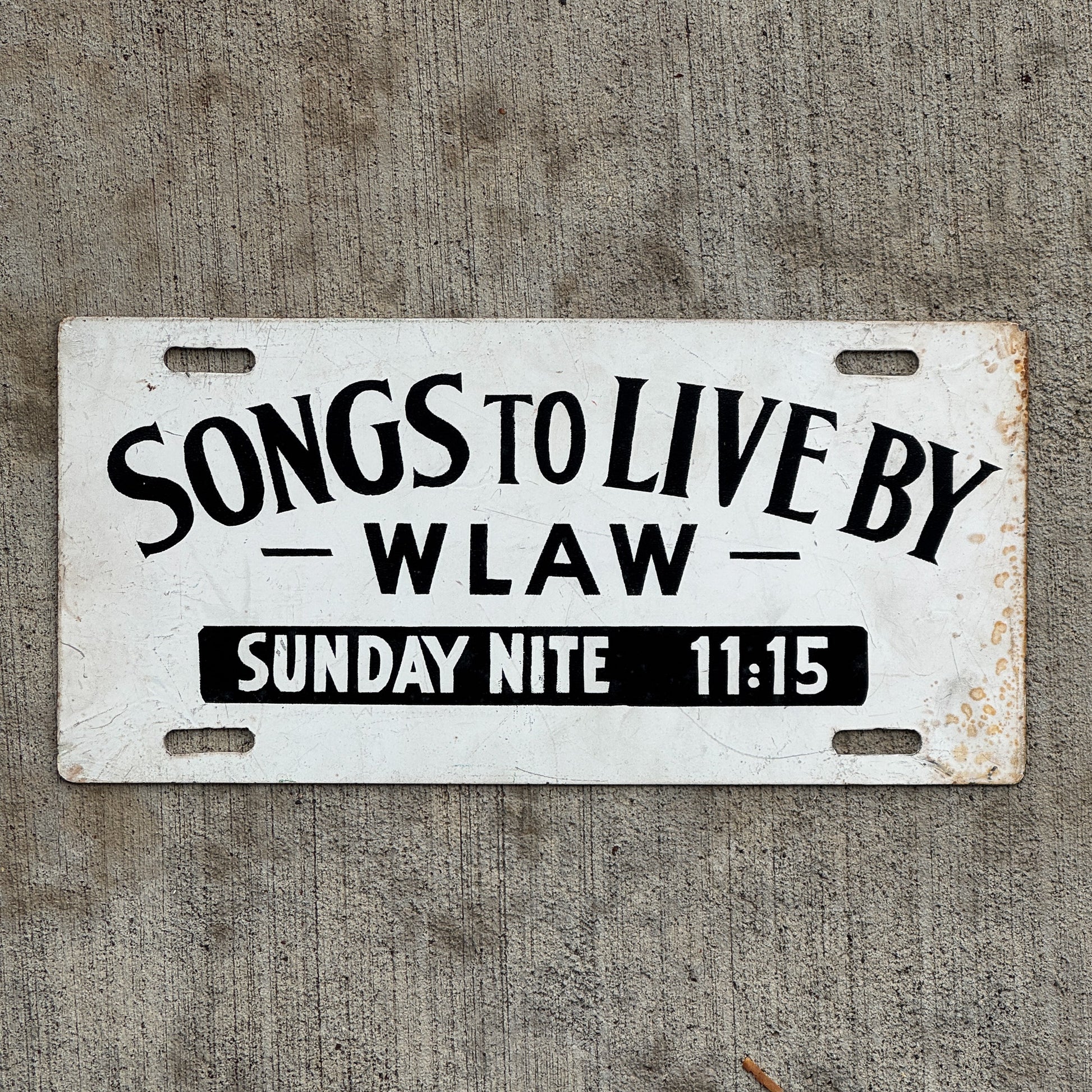 Photo of a 1960 Era Songs to Live By WLAW Massachusetts Booster License Plate Auto Tag Garage Decor Vintage AM Radio Station with original patina