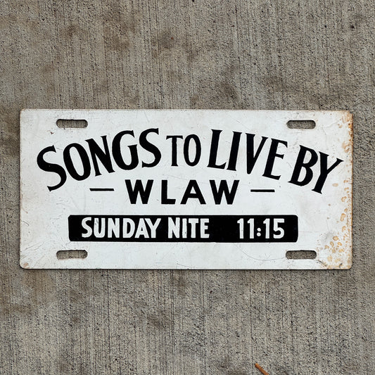 Photo of a 1960 Era Songs to Live By WLAW Massachusetts Booster License Plate Auto Tag Garage Decor Vintage AM Radio Station with original patina