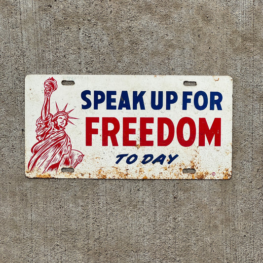 Photo of a 1960 Era Speak Up For Freedom Today Booster License Plate Auto Tag Garage Decor Vintage Statue of Liberty Graphic Metal with original patina