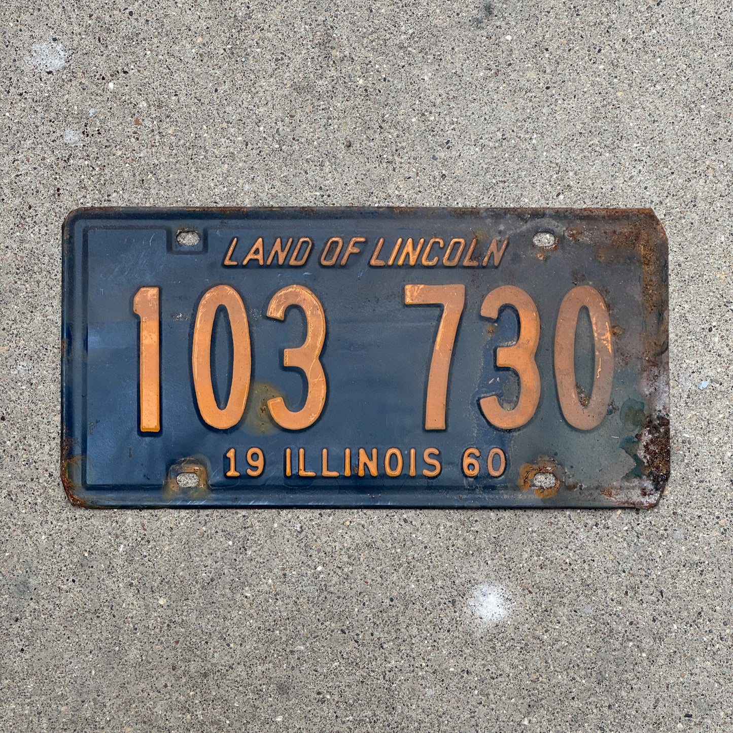 Photo of a 1960 Illinois License Plate Auto Tag 1 Vintage Garage Orange Blue 103 730 with original patina