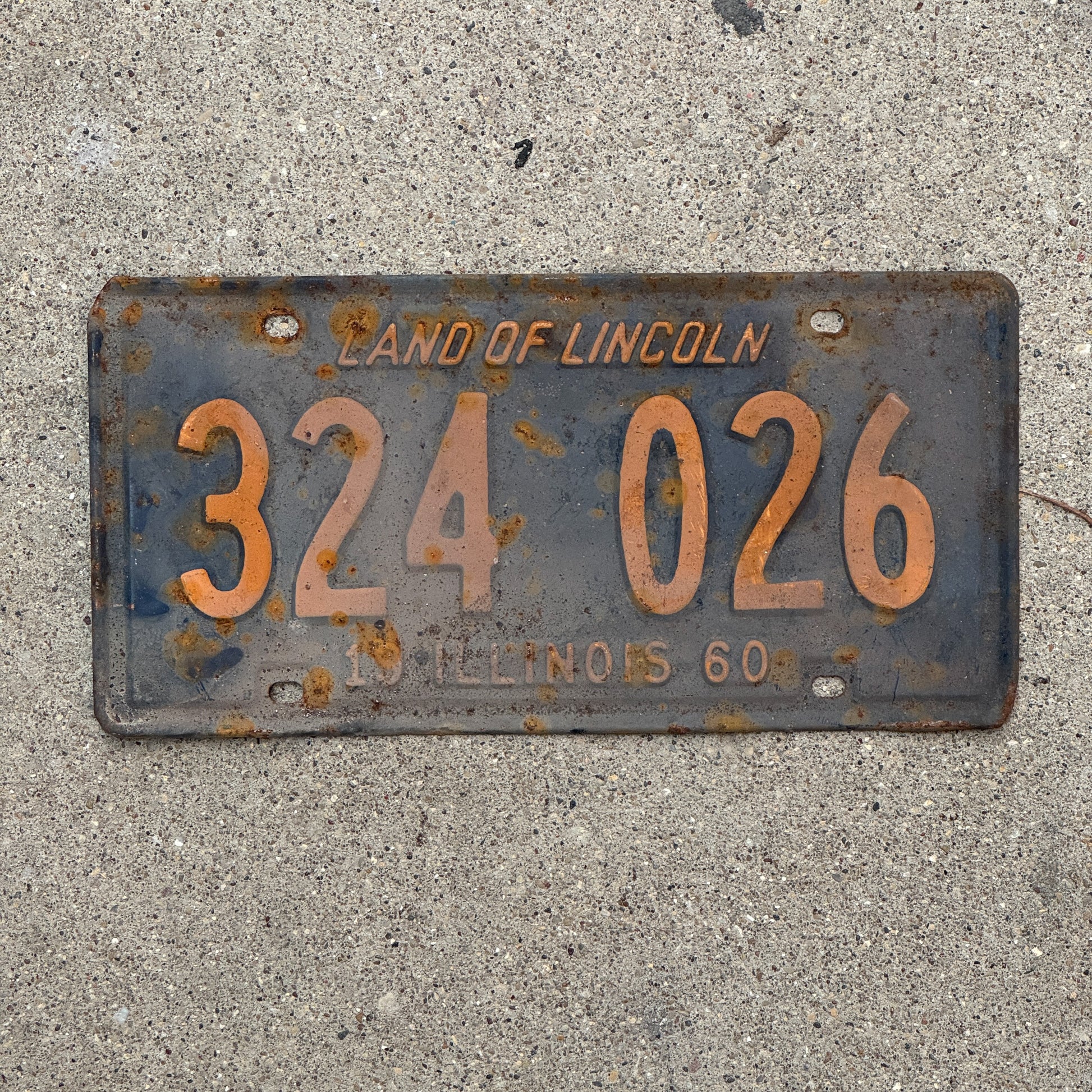 Photo of a 1960 Illinois License Plate Auto Tag 1 Vintage Garage Orange Blue 324 026 with original patina