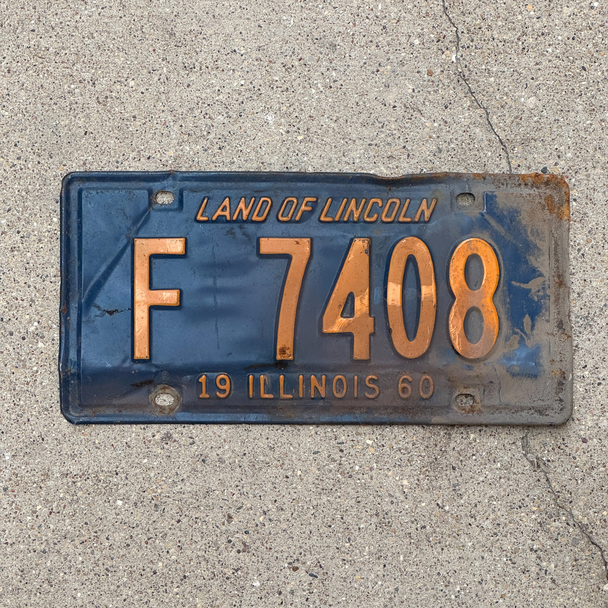 Photo of a 1960 Illinois Truck License Plate Auto Tag Garage Decor Vintage Orange Blue F 7408 with original patina