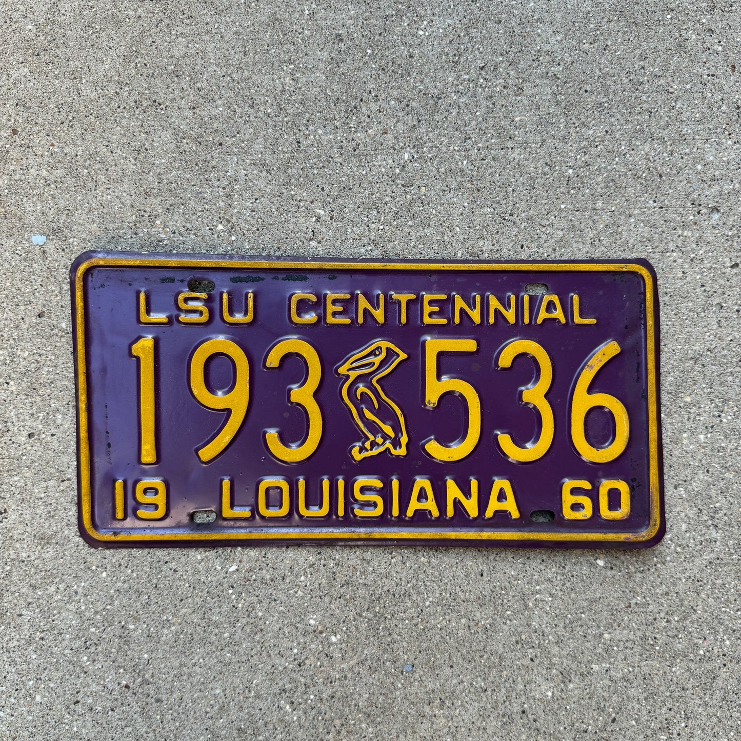 Photo of a 1960 Louisiana License Plate Auto Tag Garage Decor Vintage Louisiana State LSU Centennial Iconic Pelican 193 536 with original patina