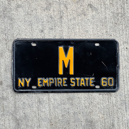 Photo of a 1960 New York Reserved License Plate Auto Tag Garage Decor Vintage Low Number Single Digit M with original patina
