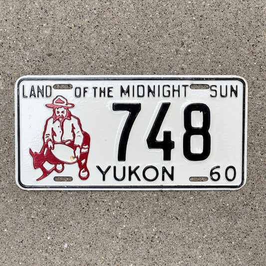 Photo of a 1960 Yukon License Plate Auto Tag Garage Decor Vintage Prospector Gold Miner Low Number Three Digit 748 with original patina