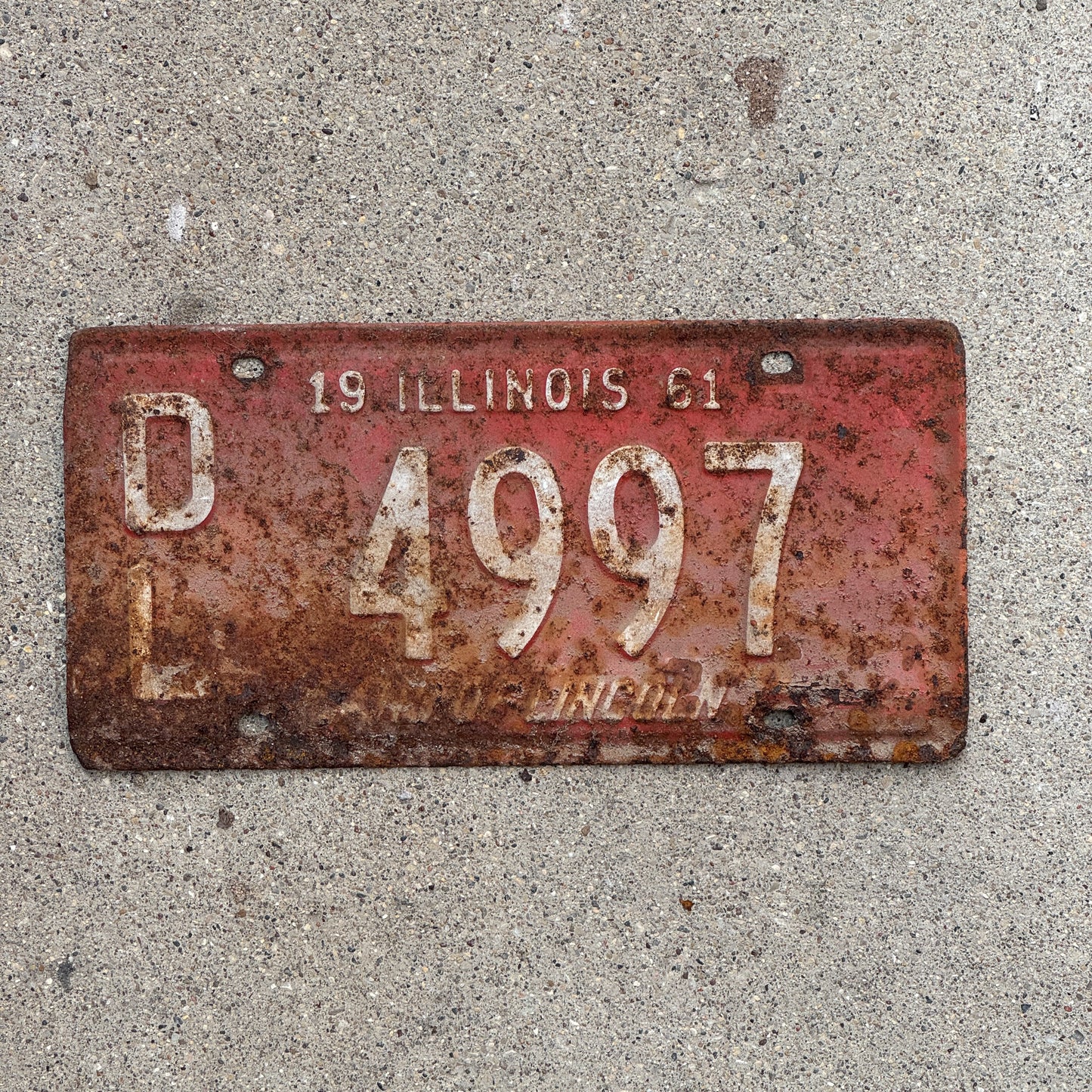 Photo of a 1961 Illinois Dealer License Plate Auto Tag Garage Decor Vintage 4997 with original patina