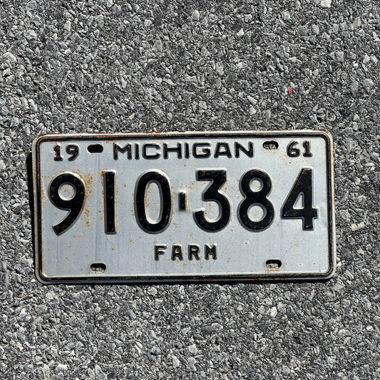 Photo of a 1961 Michigan Farm License Plate Auto Tag Garage Decor Vintage 910 384