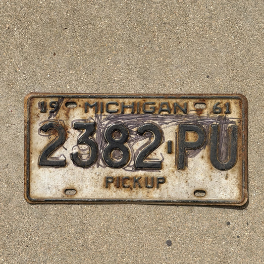 Photo of a 1961 Michigan Truck License Plate Auto Tag Garage Decor Vintage Pickup 2382 PU with original patina