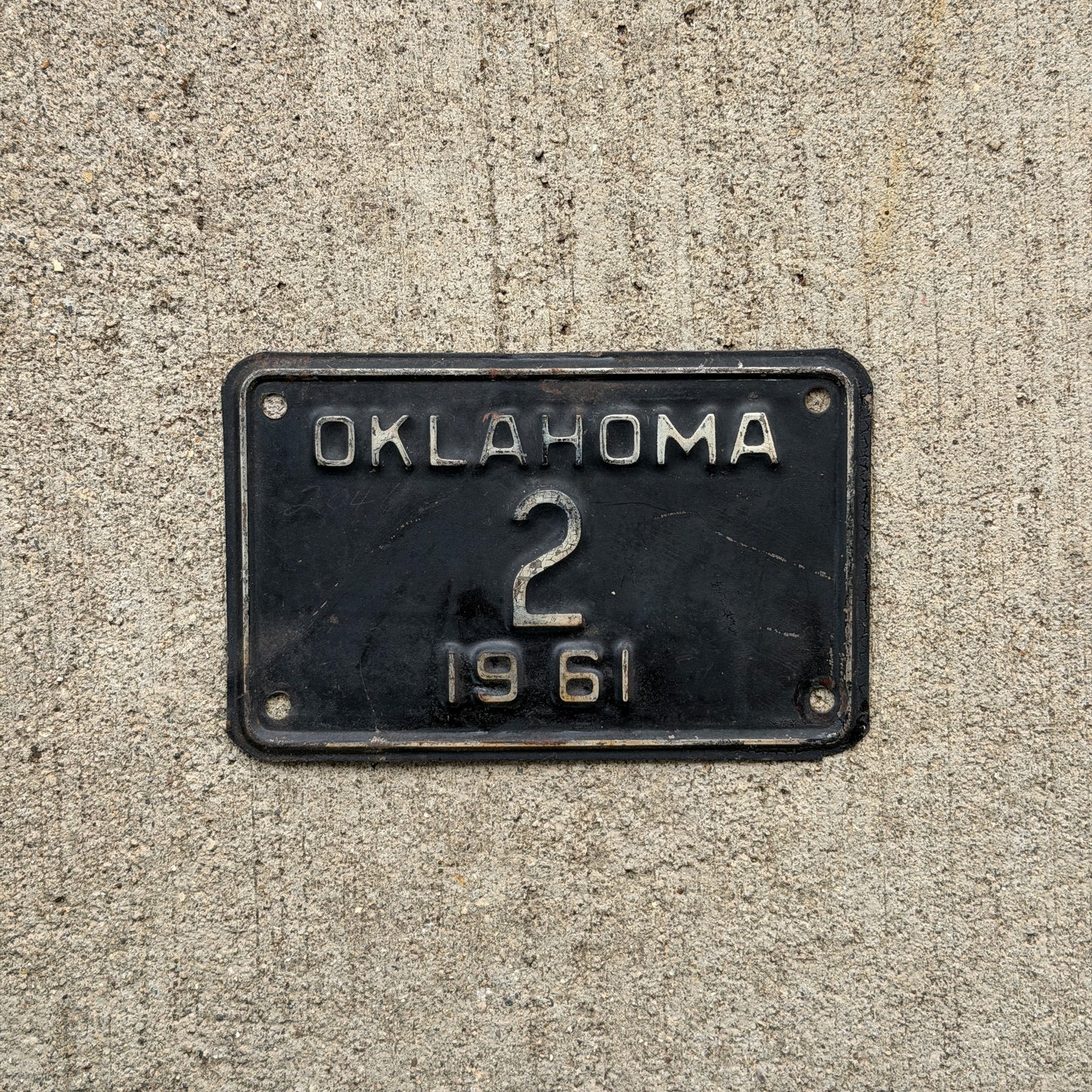 Photo of a 1961 Oklahoma Police Motorcycle License Plate Auto Tag Garage Decor Vintage Low Number Two Digit OKC Cop 2 with original patina