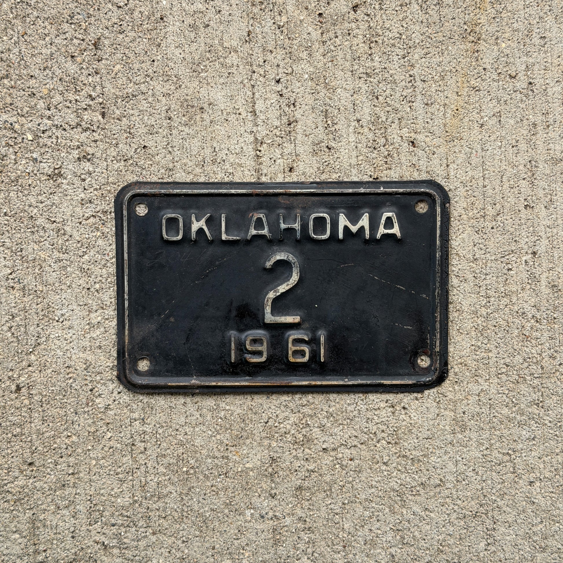 Photo of a 1961 Oklahoma Police Motorcycle License Plate Auto Tag Garage Decor Vintage Low Number Two Digit OKC Cop 2 with original patina