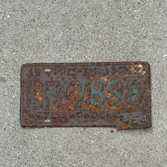 Photo of a 1962 1964 Michigan License Plate Auto Tag Garage Decor Vintage LR 7898 with original patina