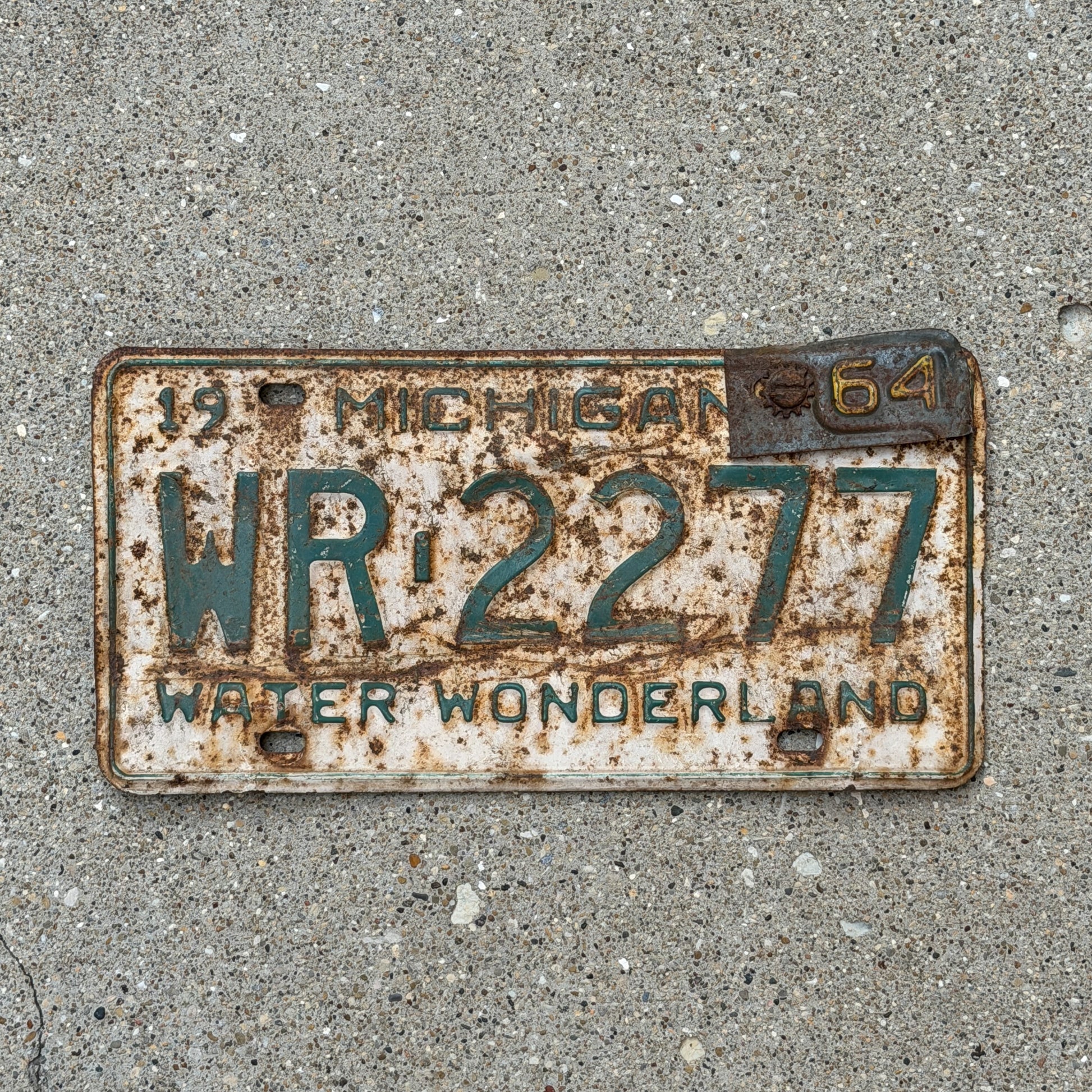Photo of a 1962 1964 Michigan License Plate Auto Tag Garage Decor Vintage WR 2277 with original patina