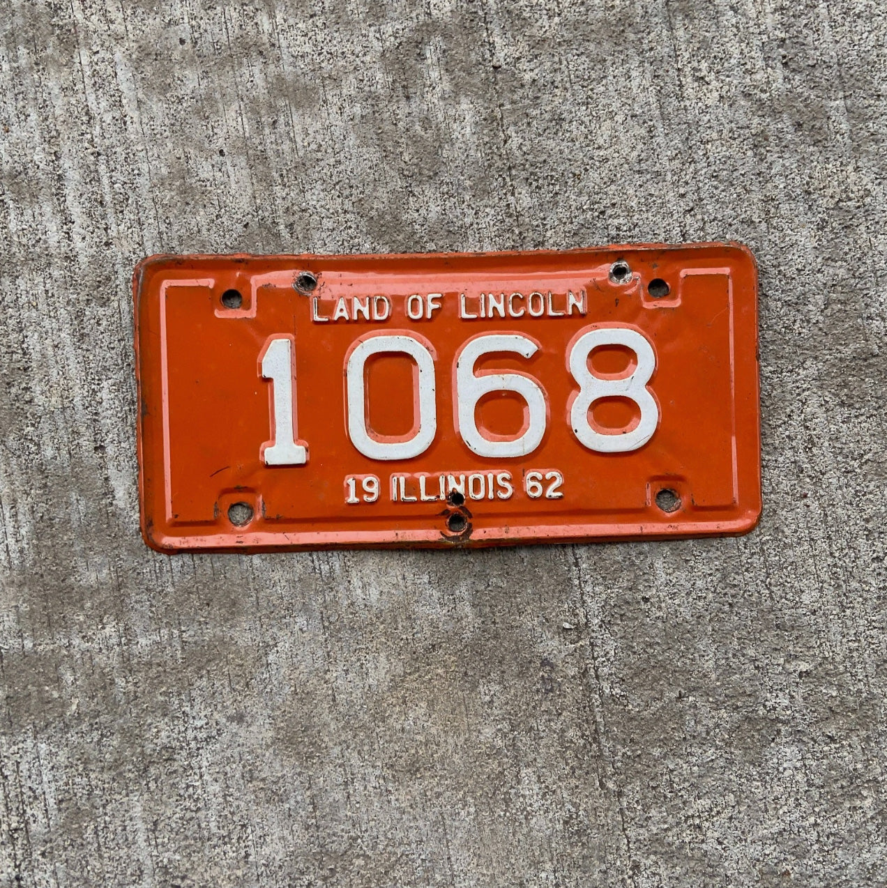 Photo of a 1962 Illinois Motorcycle License Plate Auto Tag Garage Decor Vintage Low Number Four Digit 1068 with original patina
