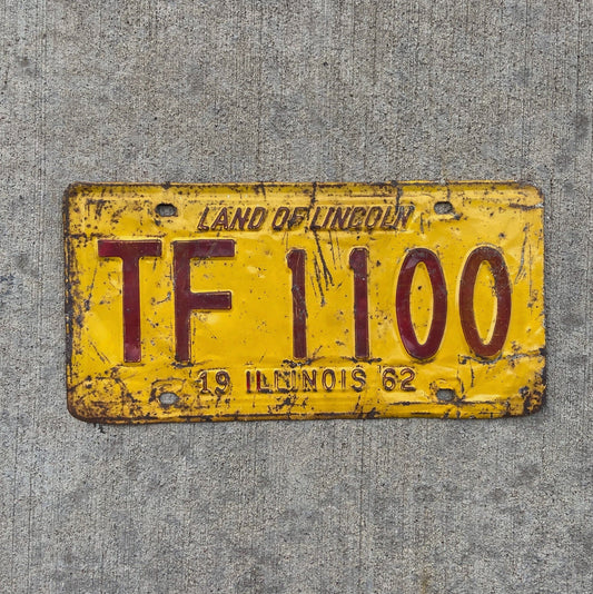 Photo of a 1962 Illinois Truck Mileage Tax License Plate Auto Tag Garage Decor Vintage TF 1100 with original patina